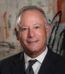 A person in a suit and tie

Description automatically generated with medium confidence