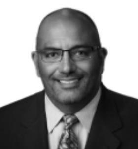 A person wearing glasses and a suit

Description automatically generated with medium confidence