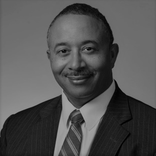 A person in a suit and tie

Description automatically generated