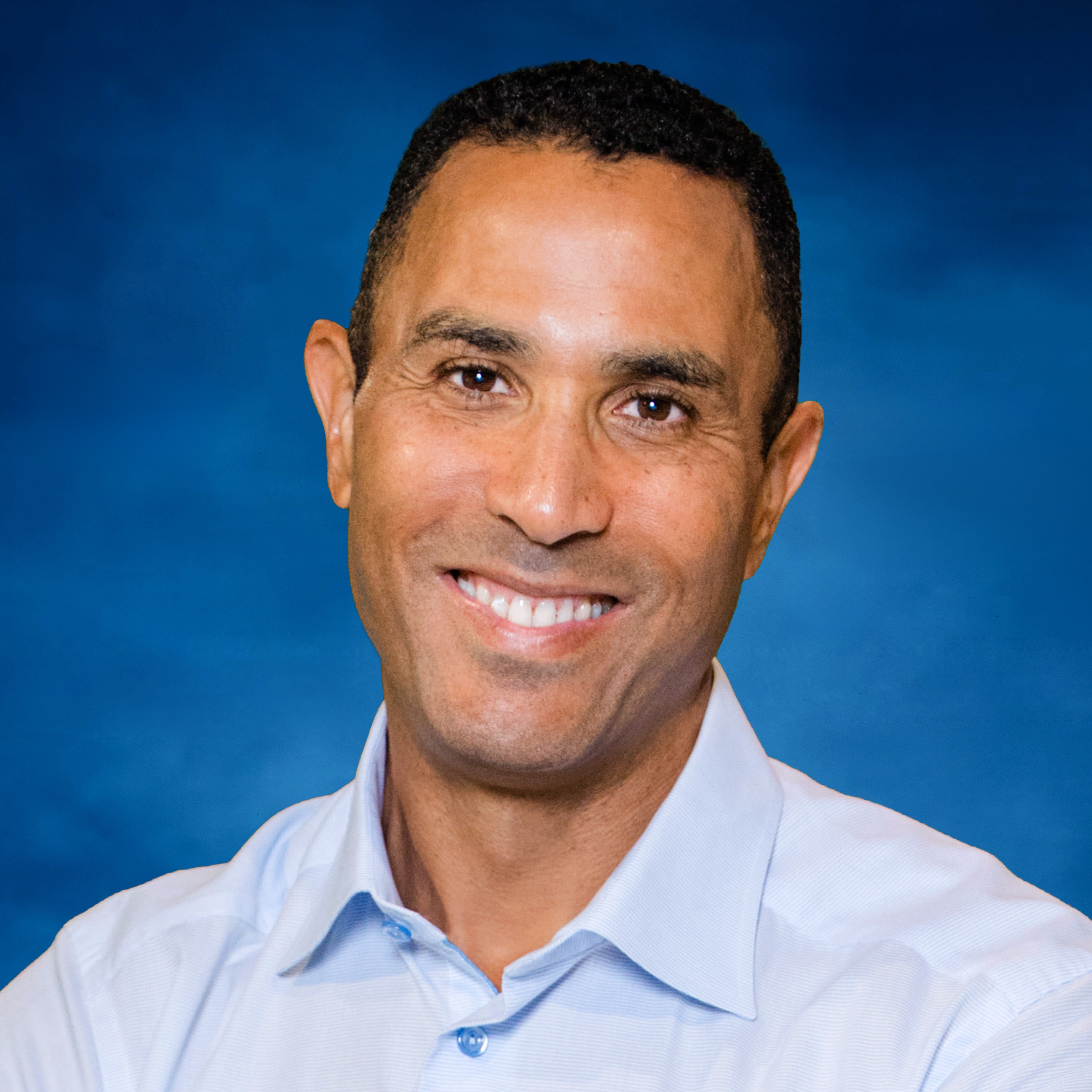 charles-young-headshot-2026 blue background square.jpg