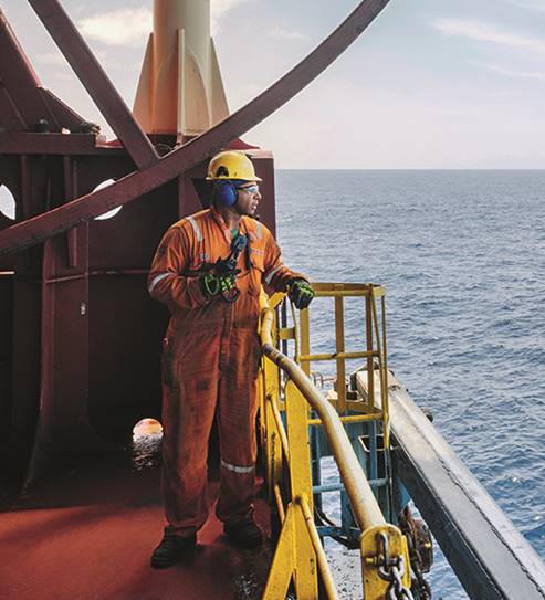 A person standing next to a body of water
Description automatically generated