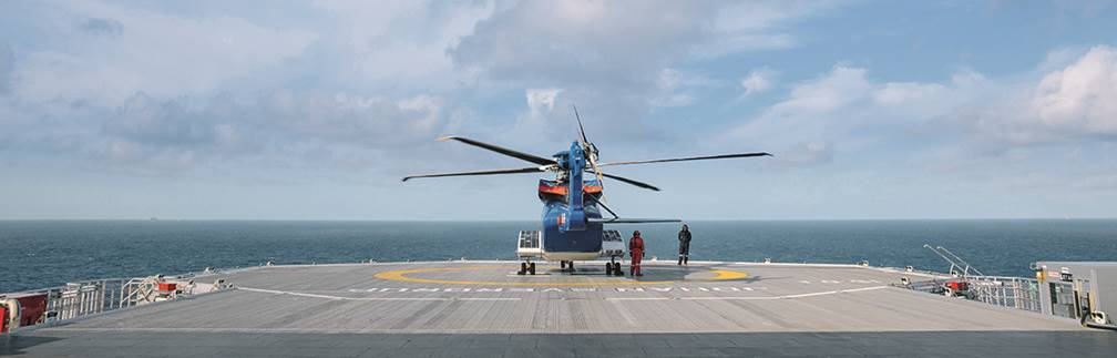 A boat sitting on top of a sandy beach next to the ocean
Description automatically generated