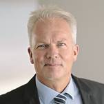 A person wearing a suit and tie
Description automatically generated