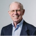 A picture containing person, person, suit, wall  Description automatically generated